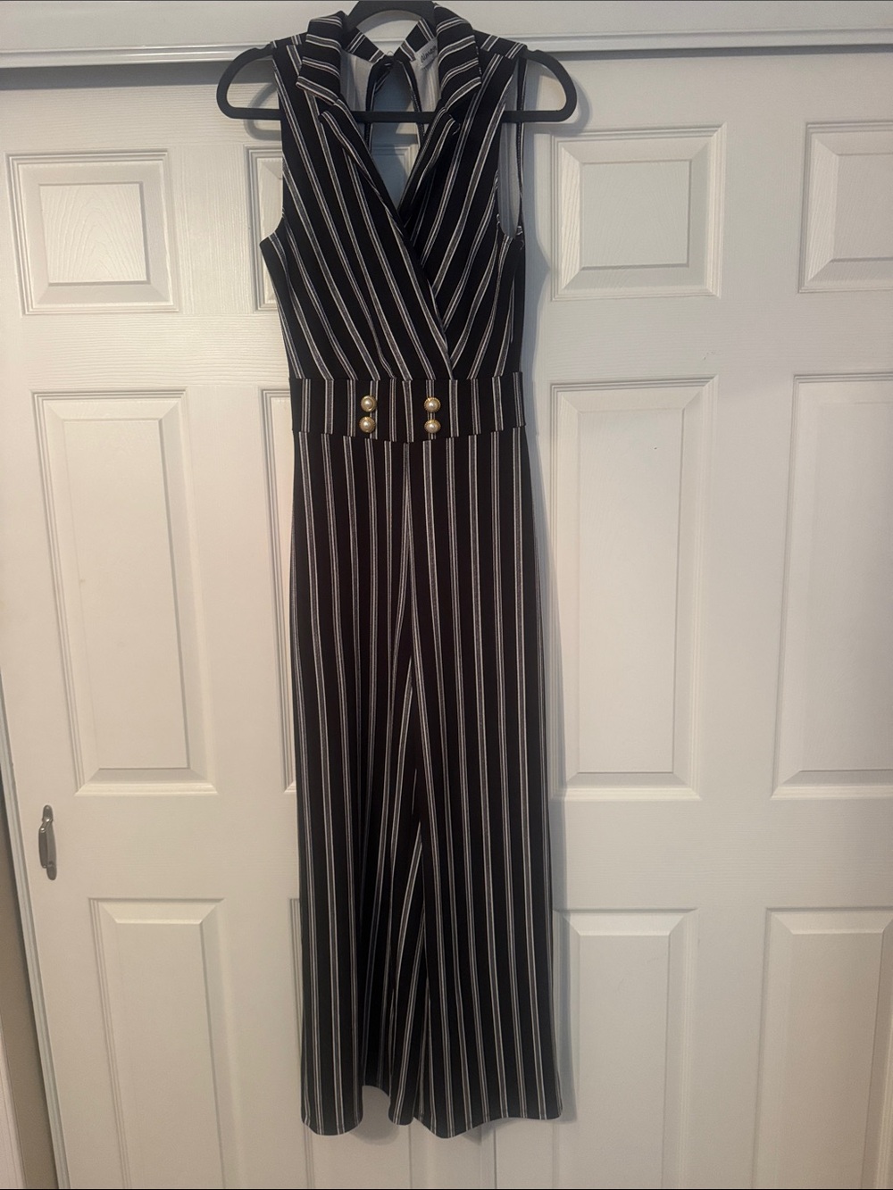 Sleeveless Black Striped Jumpsuit with Gold Pearl Buttons.
